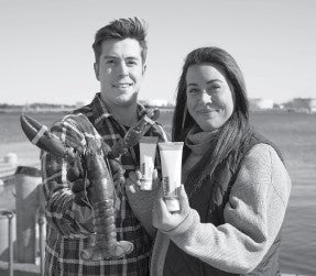 Two people by the water hold a live lobster and skincare tubes, showing a marine-derived lobster protein product.