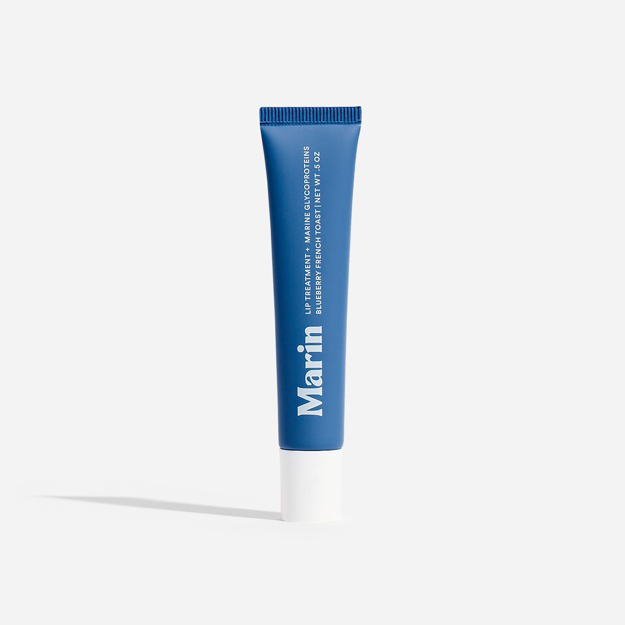 Blue Marin lip tube; label reads 'LIP TREATMENT + MARINE GLYCOPROTEINS BLUEBERRY FRENCH TOAST NET WT .5 OZ'