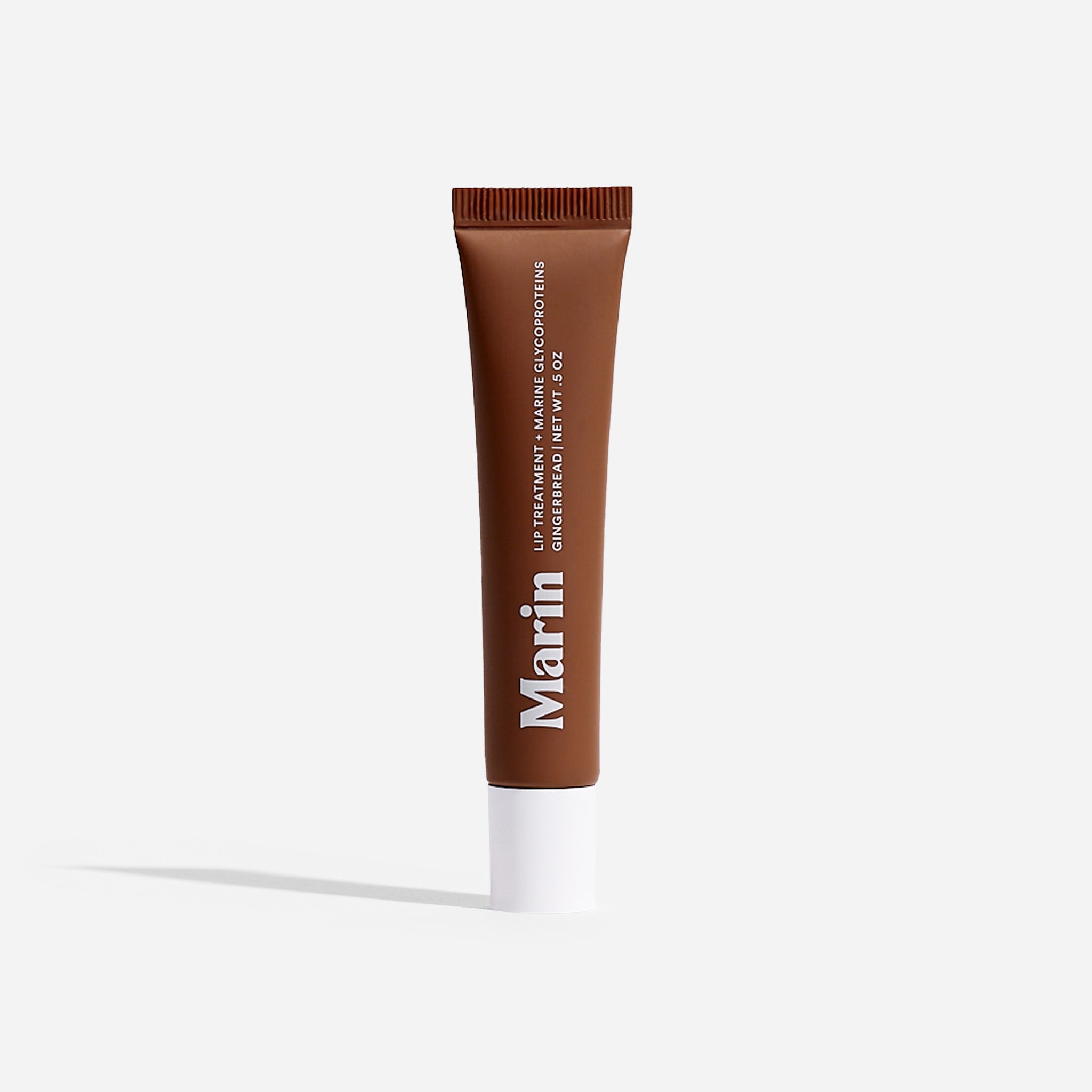 Marin — LIP TREATMENT + MARINE GLYCOPROTEINS GINGERBREAD | NET WT .5 OZ, brown squeeze tube with white cap