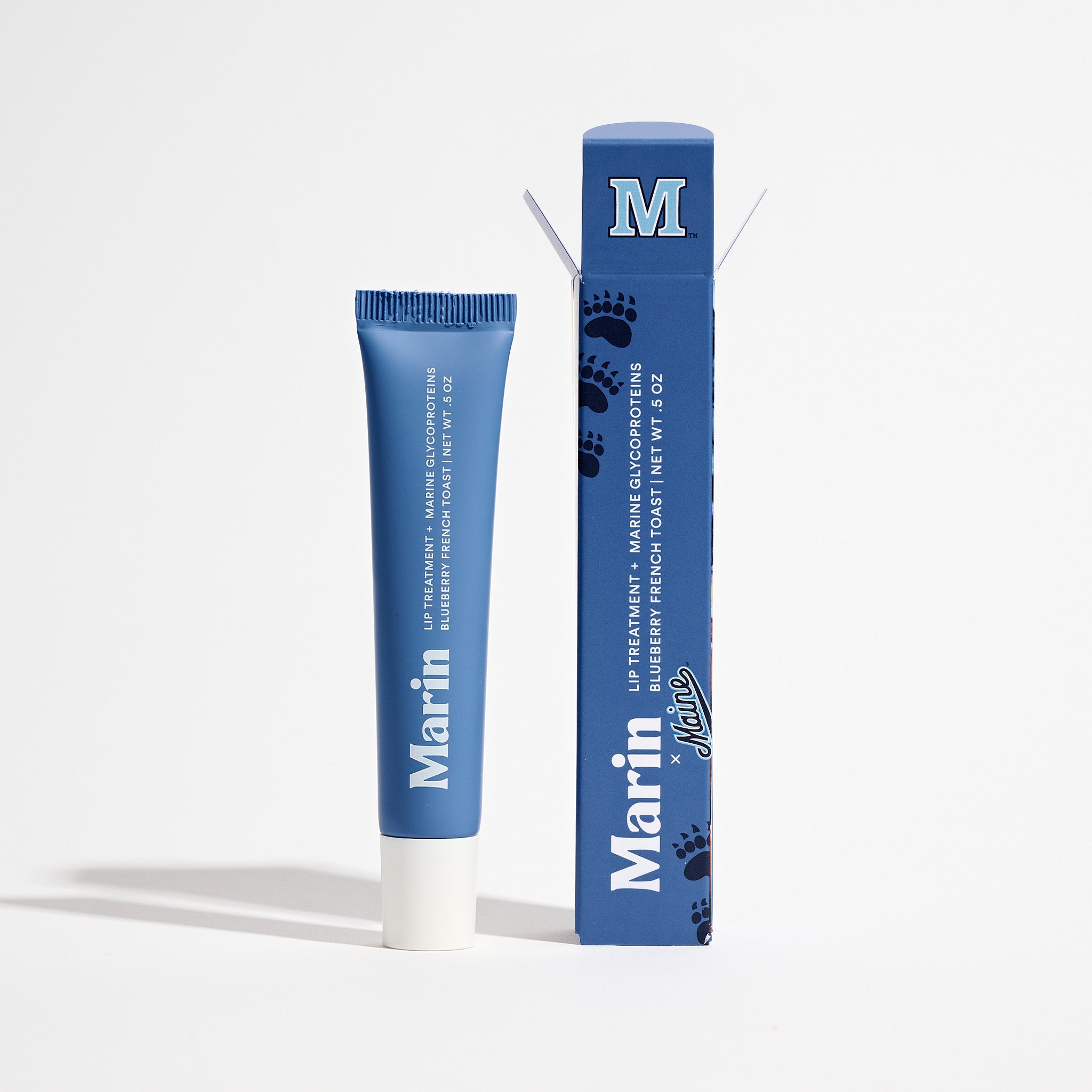 Blue lip tube and box labeled 'Marin' with 'M' logo - text: Lip Treatment Blueberry French Toast