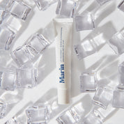 Marin lip treatment tube among clear ice cubes — 'LIP TREATMENT + MARINE GLYCOPROTEINS UNSCENTED NET WT .5 OZ'