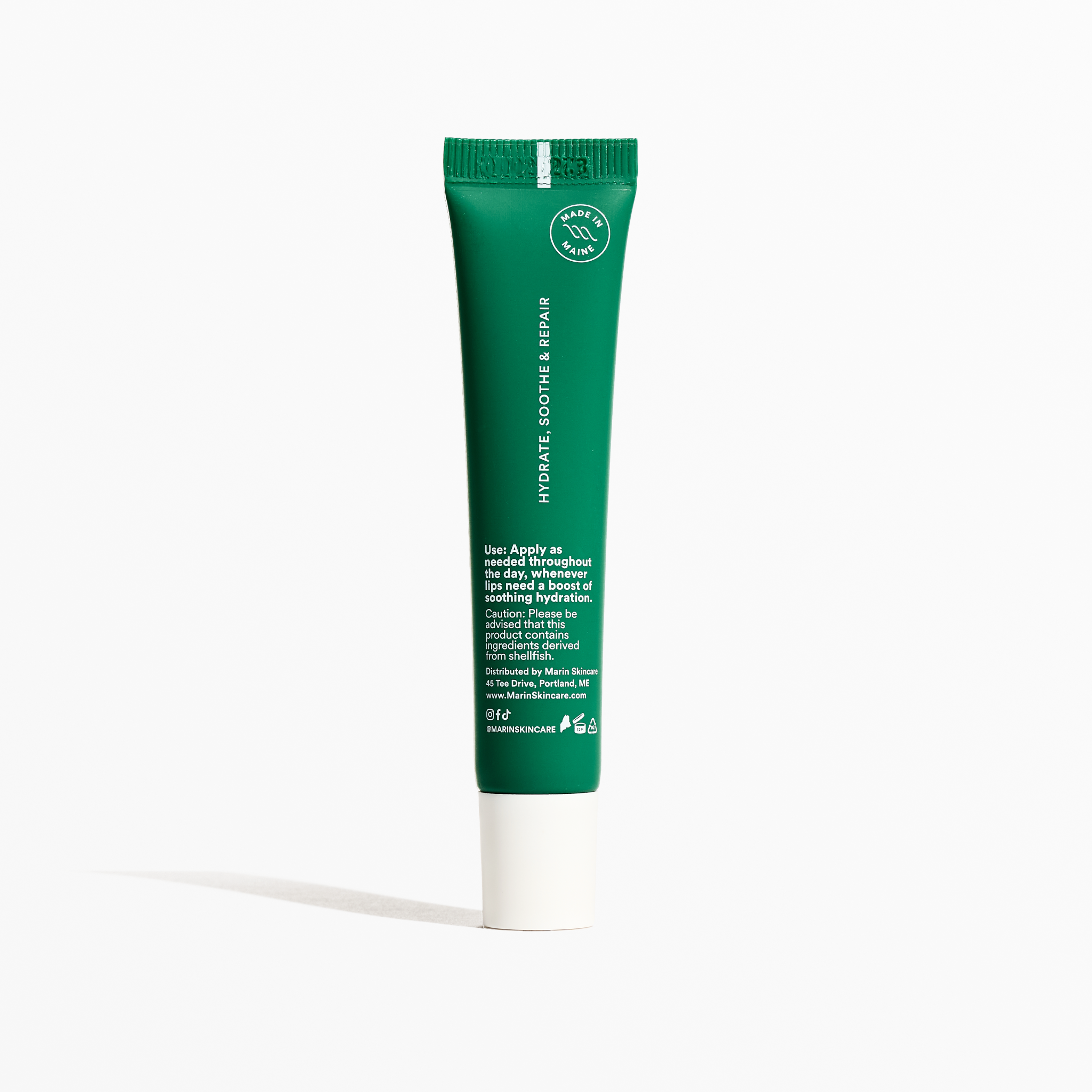 Green lip treatment tube labeled "HYDRATE, SOOTHE & REPAIR" with "MADE IN MAINE" badge