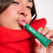 Person applying Marin lip tube to glossy lips