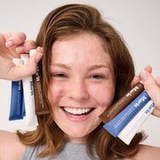 Front view of Lip Triple trio showcasing three lip treatment tubes — unscented white, blueberry-tint blue, and caramel brown — on white background