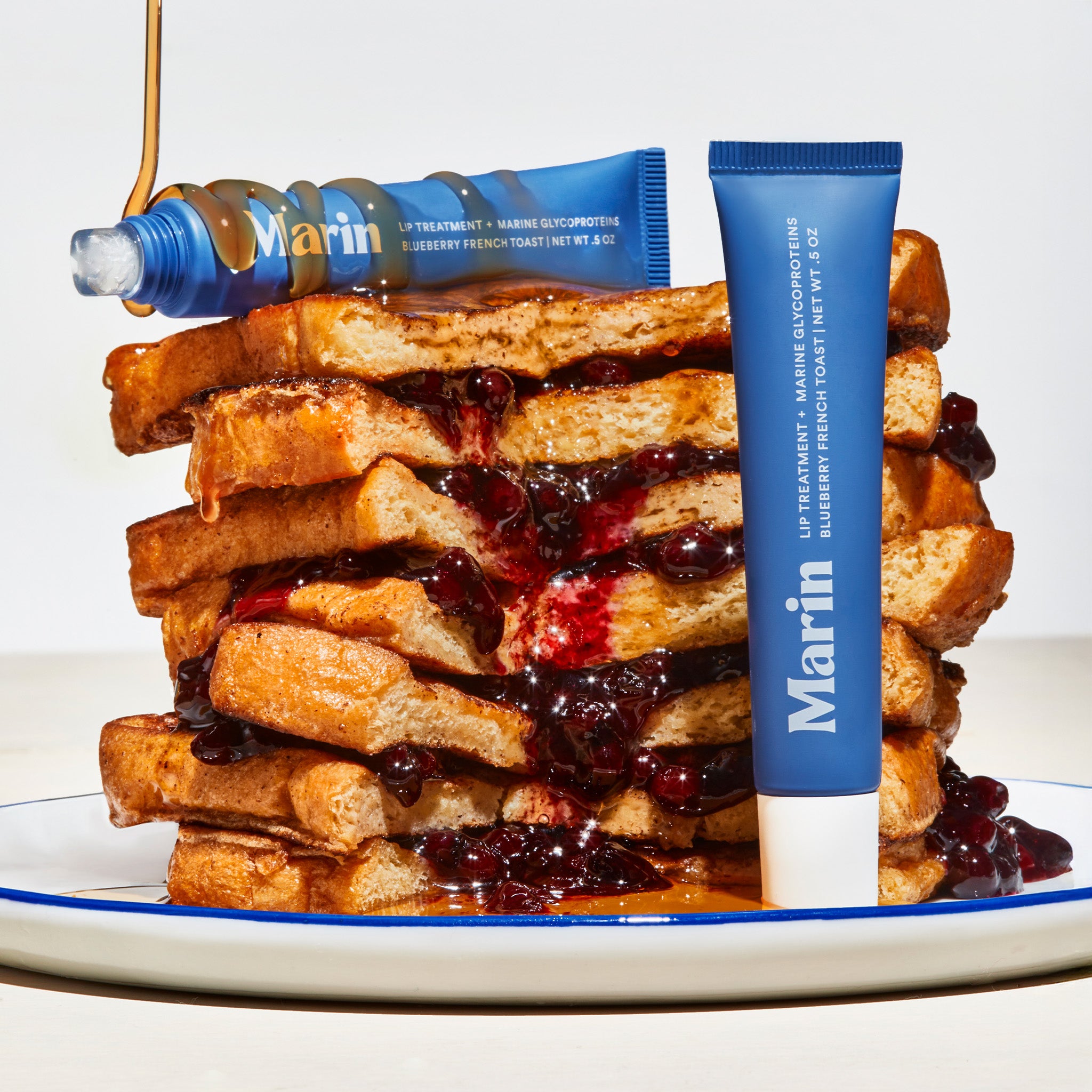 Marin LIP TREATMENT GLYCOPROTEINS BLUEBERRY FRENCH TOAST tube on syrupy stacked French toast