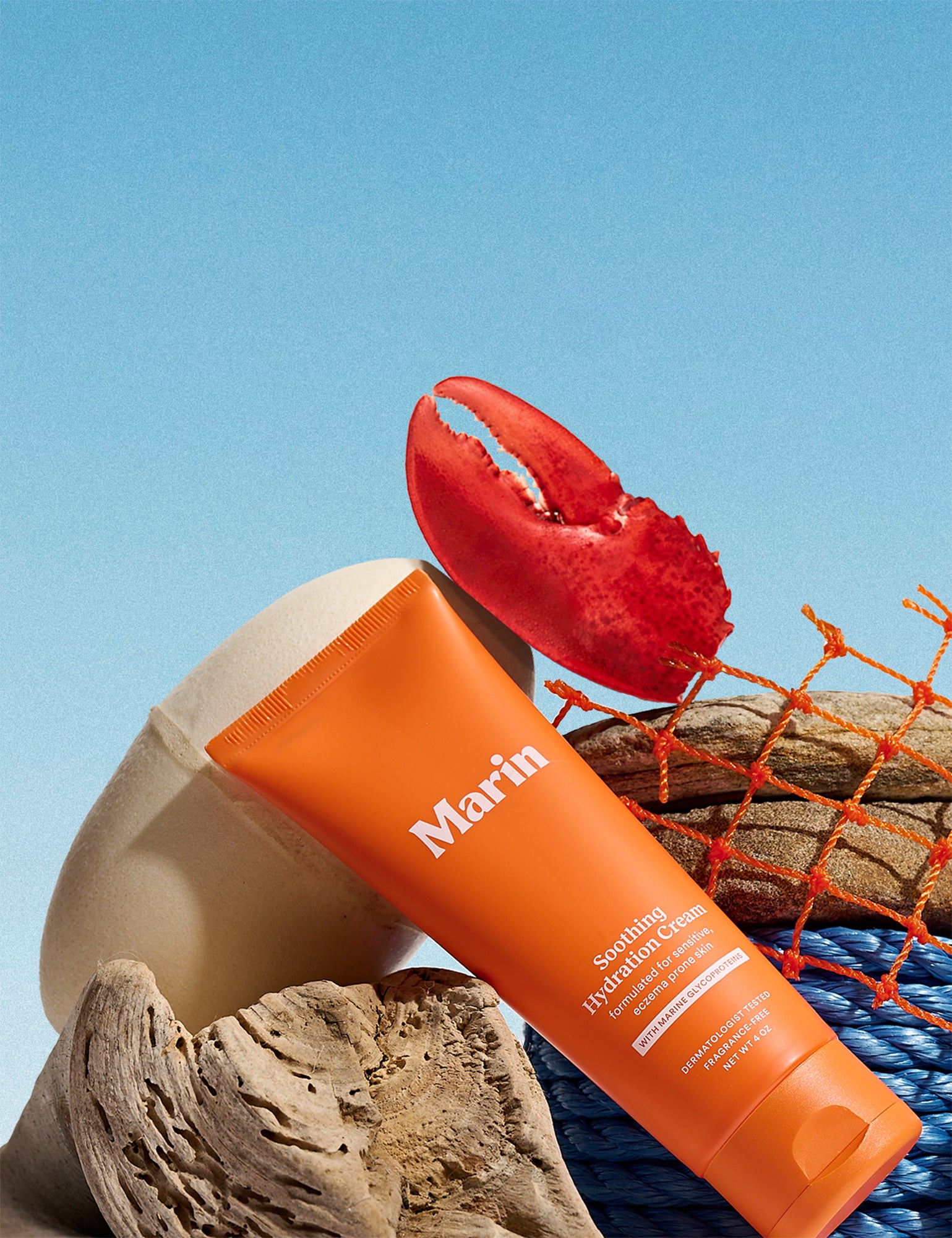 Marin Skincare Soothing Hydration Cream orange tube with driftwood, blue rope and a red lobster claw