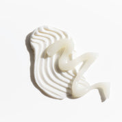 Creamy white smear topped with a translucent gel swirl on white background — Marin Skincare texture shot