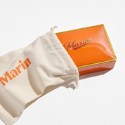Orange box labeled Marin and LOBSTER CO., partially inside a cream drawstring bag printed with Marin.